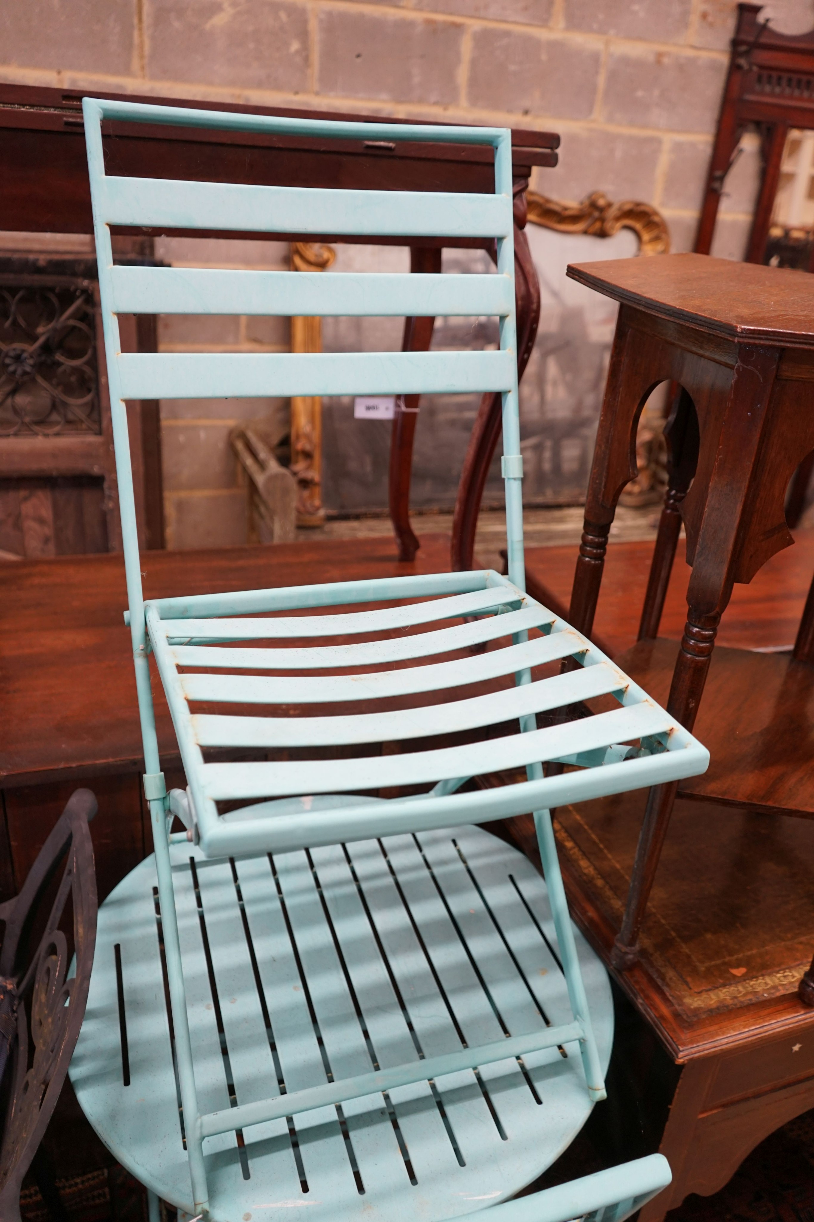 A painted aluminium bistro table, diameter 60cm, height 70cm and two chairs